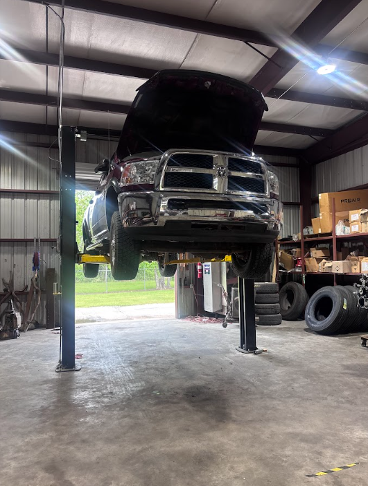 Truck raised on the two-post lift